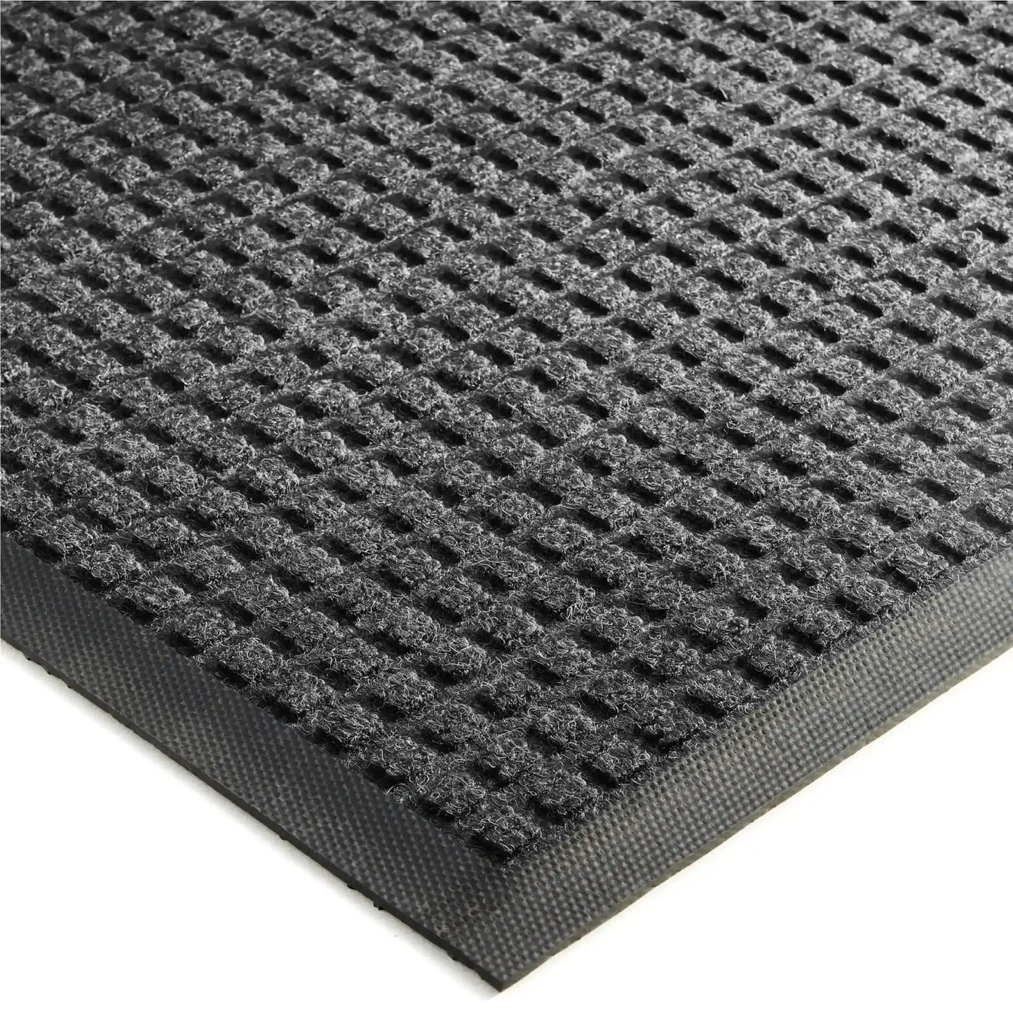 Vue détaillée de la structure alvéolée d’un tapis d’entrée professionnel conçu pour retenir l’eau et les débris.