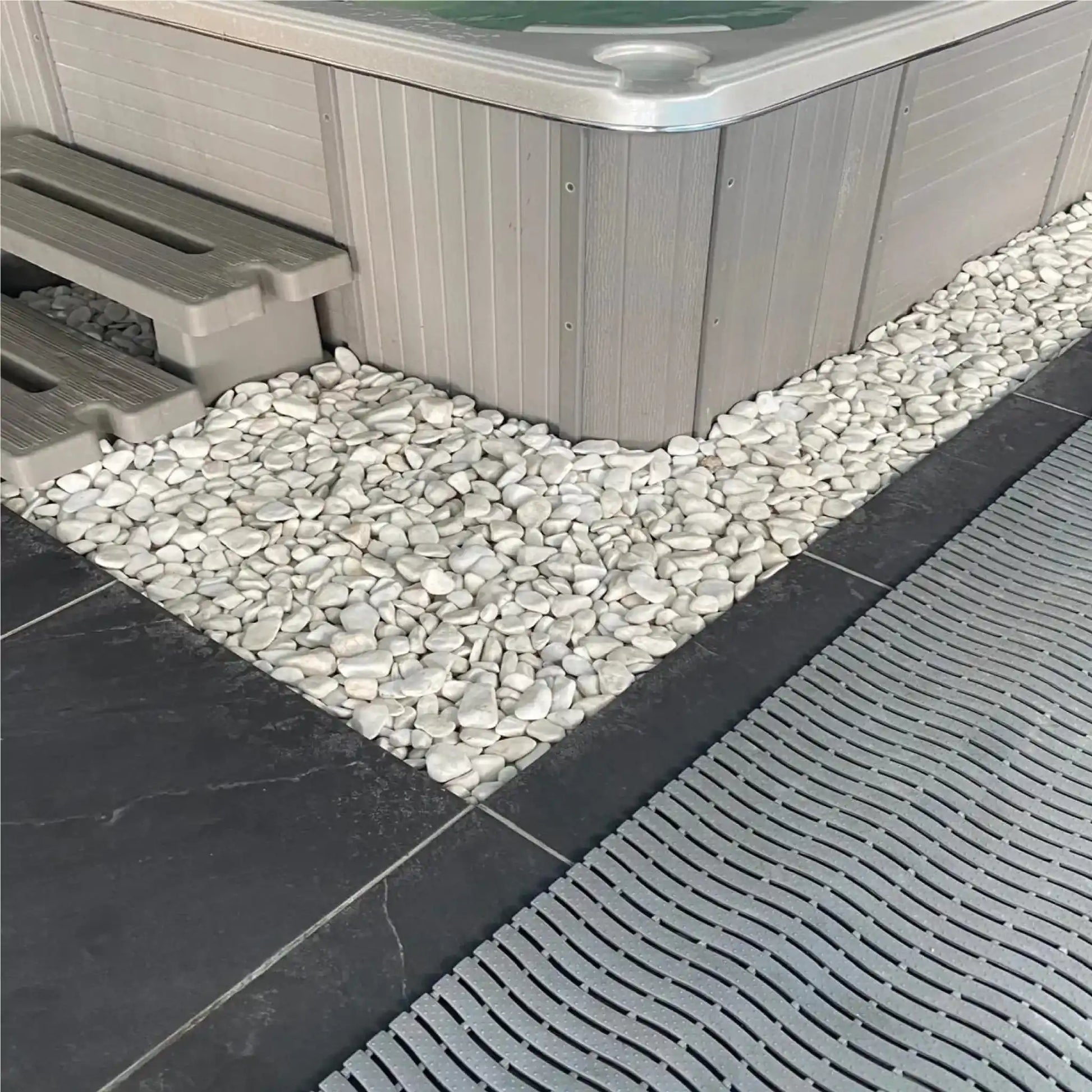 Revêtement drainant antidérapant installé autour d’un spa pour évacuer l’eau et sécuriser les déplacements pieds nus.