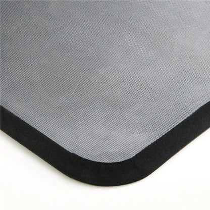 Détail de l’épaisseur et de la finition d’un tapis anti-fatigue professionnel en mousse avec bords biseautés de sécurité.