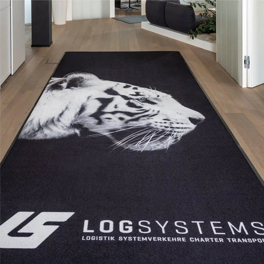 Tapis logo personnalisé grand format XXL installé dans les locaux d’une entreprise de logistique pour renforcer l’identité visuelle dès l’entrée.